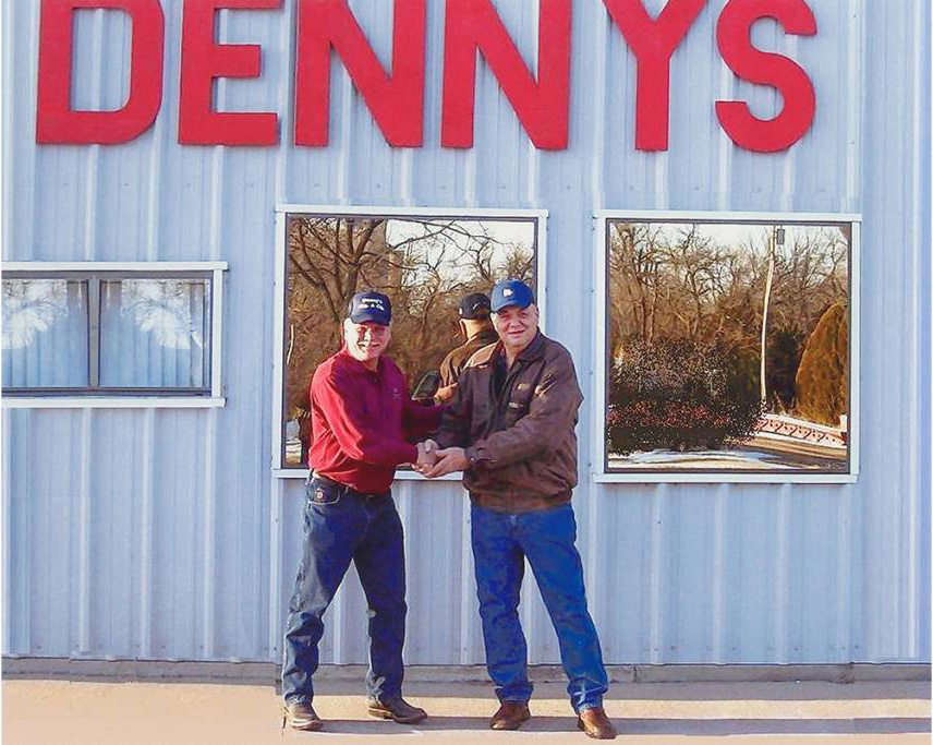 Carl shaking hands at the sale of Dennys Heating and Cooling in Newton to Hanna