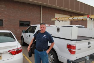 Hanna technician in front of HVAC truck on way to a service call