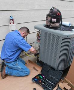 Hanna HVAC technician working on outside broken air conditioner