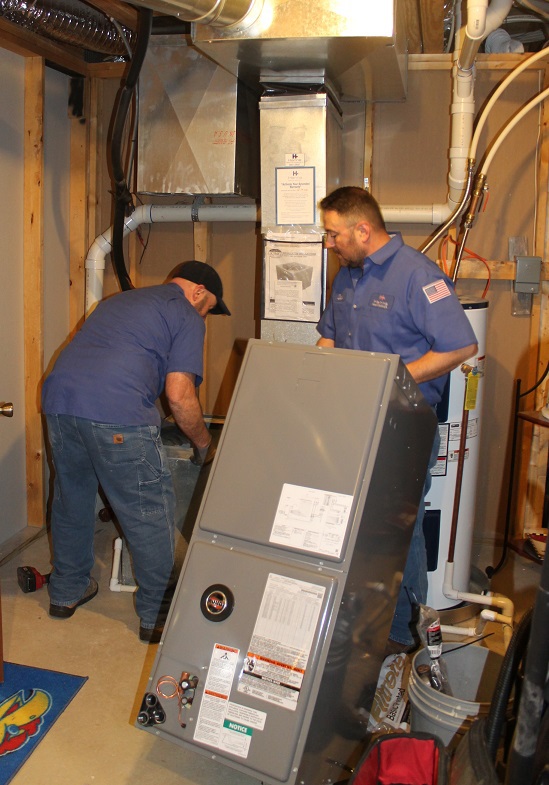 Hanna heating technicians installing new high efficiency furnace in Wichita home.