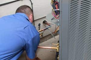 Hanna AC technician repairing an air conditioner in West Wichita