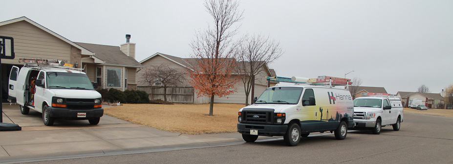 Photo of Hanna HVAC service vans doing installation work in Wichita neighborhood
