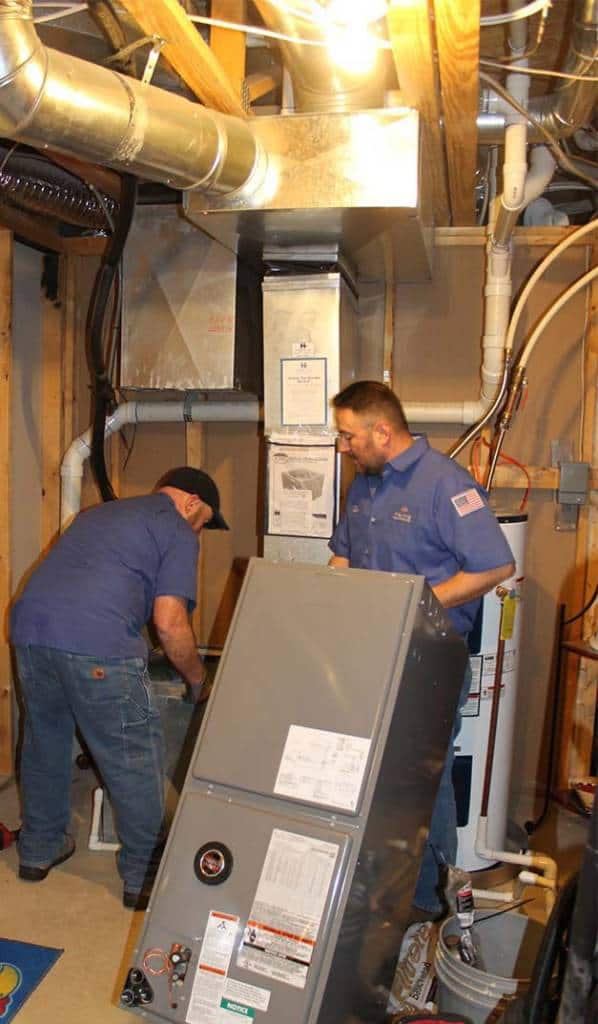 Hanna Heating technicians installing a new furnace in a Wichita home