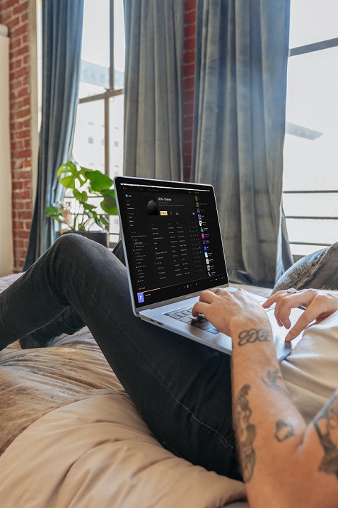 Guy working from home on his bed. Photo by Vollume Control on Unsplash