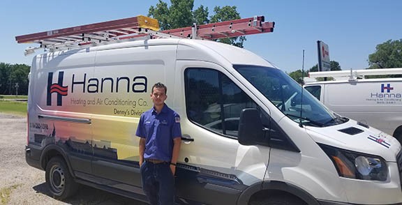 Hanna Heating & Air technician in front of HVAC vehicle